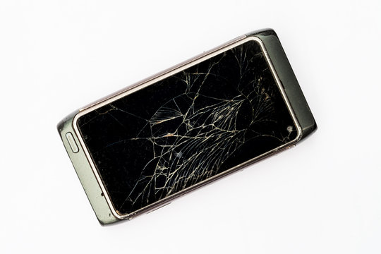 Smartphone with a broken screen. White cracks on a black background.