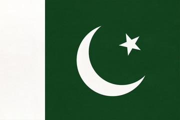 Republic of Pakistan national fabric flag with emblem, textile background. Symbol of international world asian country.