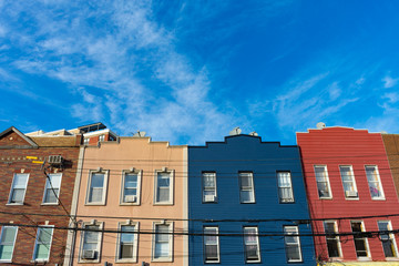 Fototapeta na wymiar A Row of Colorful Old Buildings and a Background of a Blue Sky in Astoria Queens of New York City