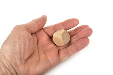 Wooden dice in the hand on a white background