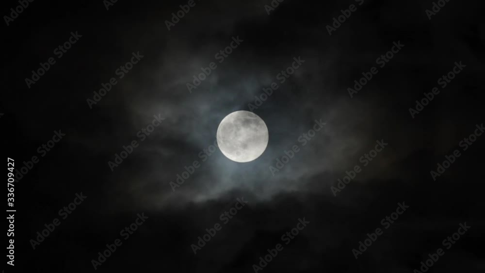 Wall mural super moon on 7th april 2020, full moon with dark clouds moving past.