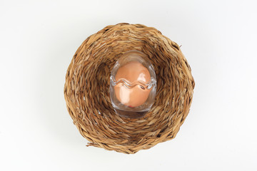 Egg in egg shape glass container protection shell on white background safety