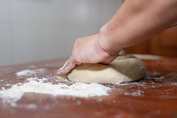 Close up of woman's hands making dough for homemade bread