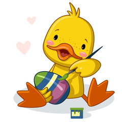 cute duck paints an easter egg with paints