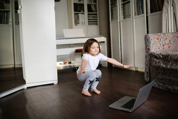 child dancing,aerobics in online video chat laptop