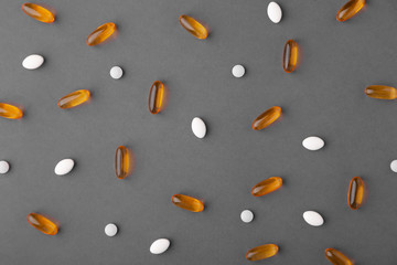 Assortment pharmaceutical medicine vitamins, pills, drugs on gray background