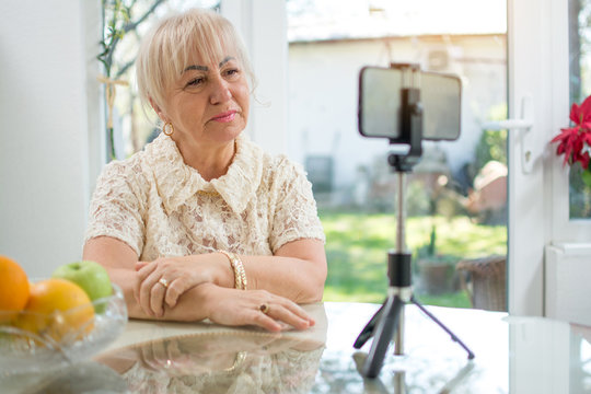 Sad Mature Woman Having A Video Call Over Smart Phone At Home. Middle Aged Woman Crying During Online Video Call With Her Family.