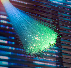 Fiber optics network cable on technology background
