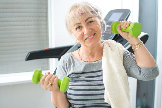 Active Middle Age Mature Woman Working Out With Weights At Home Gym. Stay At Home, Active Seniors, Home Quarantine, Corona Virus Concept.