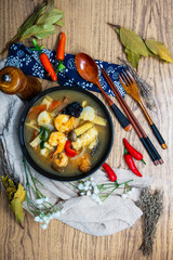 Bowls of Asian soup noodles and vegetables with Chopstick