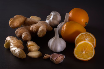 Ginger, garlic and lemon - a means to protect against viral infection and colds on a dark table. Low key