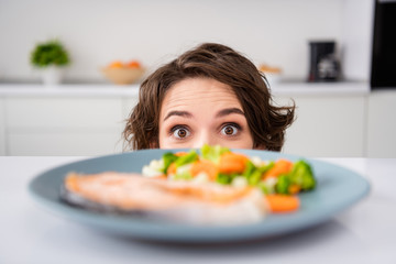 Close up photo of housewife lady cunning tricky hungry eyes look from under table ready to eat...