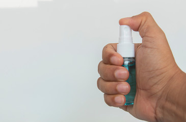 Blur and move  blue alcohol spray bottle on hand  on white background for cleaning,