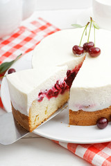 Closeup homemade cherry pie with delicate yogurt filling on white wooden table