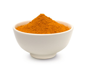 Turmeric (curcumin) powder in a white bowl isolated on a white background.
