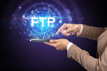 Obraz premium Close-up of a touchscreen with FTP abbreviation, modern technology concept