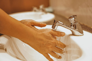 covid19 pandemic prevention wash hands with soap use soap and washing hands under the water tap. hygiene concept hand detail.selective focus.