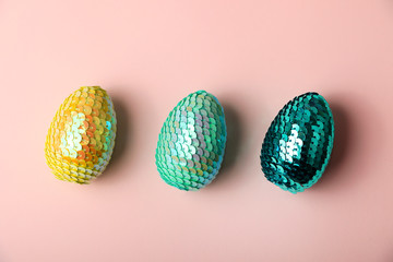 Colorful glossy easter eggs lying in row on the pastel background.Minimal concept.Modern background.