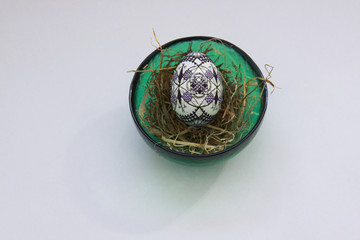 Traditional handmade Easter egg in glass bowl