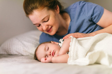 How to put a baby to sleep? Nine-month-old baby sleeping in peace with mom