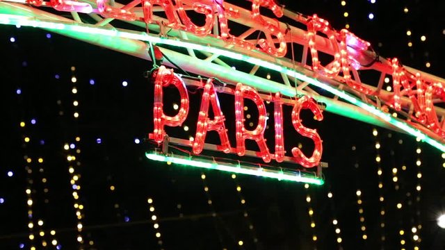 Neons of the letters of Paris at the entrance of the Christmas market on the Champs Elysees in december during Christmas time