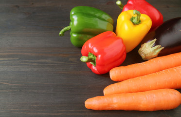 Closeup colorful fresh vegetables on dark brown wooden table with copy space