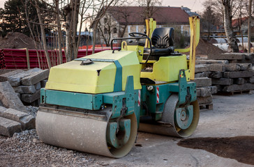 yellow and green parked old heavy asphalt roller