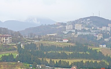 mountain city panorama in fog and rain