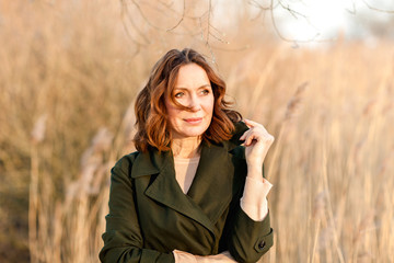 portrait of middle aged woman posing at the park