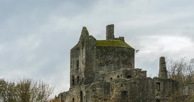 A time-lapse of a Ravenscraig Castle in Scotland perched on a rocky beach in Fife with clouds moving.