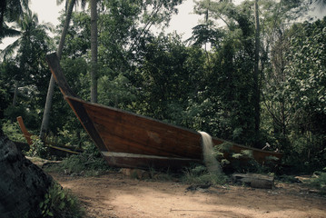 Old wooden boat in nature next to water in Thailand, Asia.