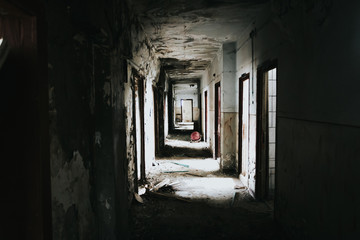 Abandoned building corridors with an eerie atmosphere. Dark tourism concept image. 