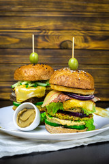 Delicious burger with juicy chicken green vegetables and olives