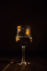 Glass of water or wine in a dark background