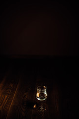 Glass of water or wine in a dark background