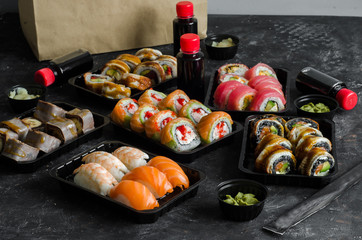 set of sushi rolls in a plastic box, delivered home ready to eat fast healthy food