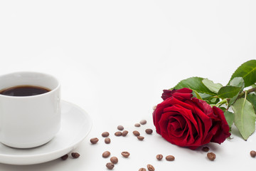 The rose and coffee Cup, with coffee beans on a white background at the bottom of the text space. The concept of a romantic morning, background for Valentine's Day, or coffee for the woman you love.