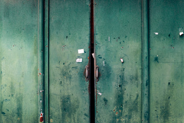 Closed old rusty metal green door background