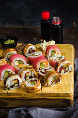 Assorted sushi roll sushi with tuna, eel, cucumber, avocado, cream cheese, red caviar. Sushi menu. Japanese food.
