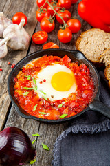 Shakshuka Scrambled eggs with tomatoes and vegetables. Breakfast. In the plate. Top view. Flat lay composition Free copy space.
