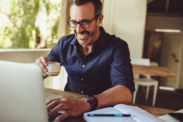 Man doing his work sitting at a coffee shop