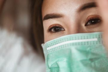Woman wearing mask protection at the window wait for epidemic situation to improve soon at home....