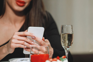 Cute woman looks in the phone.