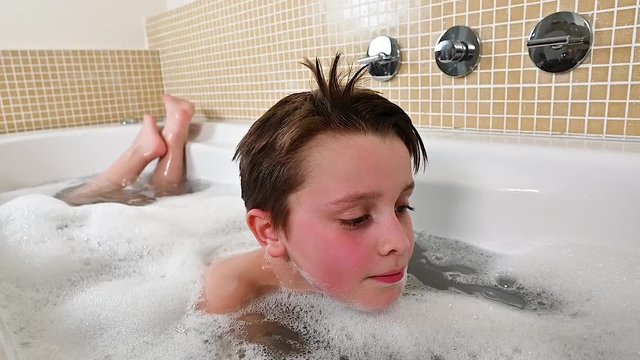 child bathing in a bathtub