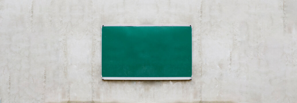 Outdoor school board, blackboard or shalk board on concrete wall background banner