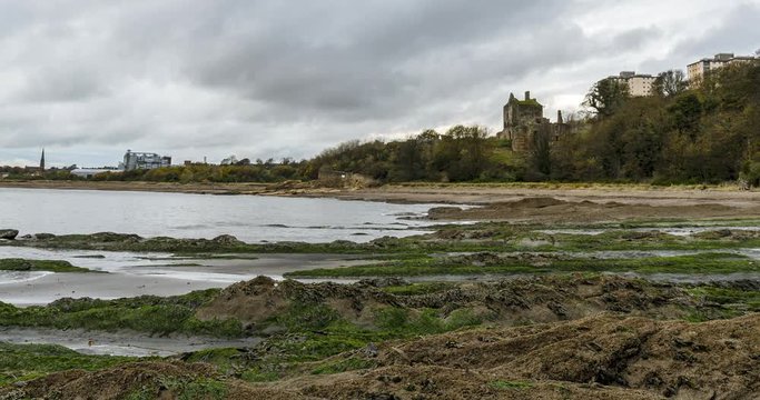A wide angle timelapse of Ravenscraig Castle in Scotland on a rocky beach in Fife.