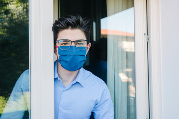 Young businessman with mask forced to stay in quarantine at home