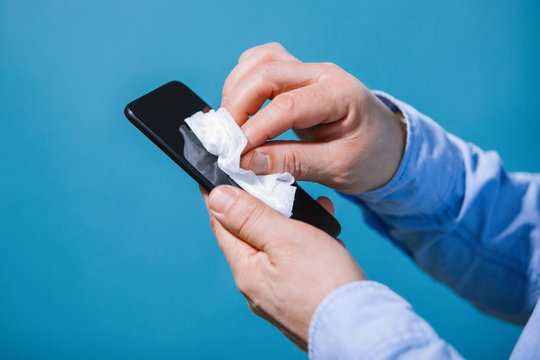 Man disinfects smartphone