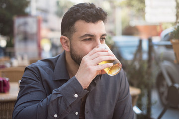 man drinking beer in bar terrace
