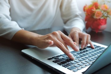 Hands of Asian woman is typing on keyboard of laptop or computer for check electronic mail, preparation of presentation in meeting, get information for shopping online or operation of internet banking